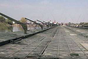 In pictures: The opening of a floating bridge linking the banks of the Euphrates River in Deir Ezzor